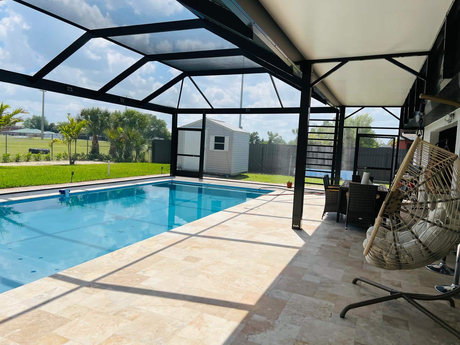 Completed panoramic pool cage with a covered roof in Cape Coral